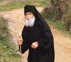 Saint paisios standing with a stick